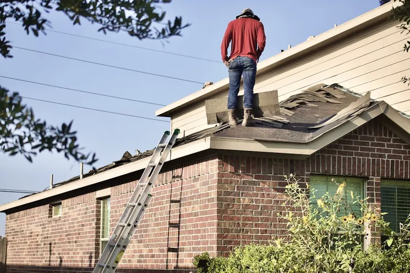 Professional roofer working on a residential roof in Rosenberg